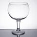 A close up of a Libbey clear super schooner glass on a reflective surface.