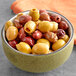 A bowl of Royal Ann Mediterranean Pitted Olive mix on a table.