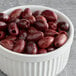 A bowl of Kalamata olives on a table.