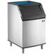 A stainless steel Manitowoc ice storage bin with a blue lid.