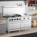 A commercial stainless steel 60-inch range with six burners, a 24-inch manual griddle, and two standard ovens, designed for liquid propane use.