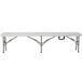 A Flash Furniture white rectangular plastic folding bench with metal legs.