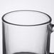 An Arcoroc clear glass mug with a handle.