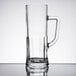 An Arcoroc clear glass beer mug with a handle.