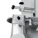 A white metal cover with a handle for an Avantco meat slicer.