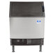 A Manitowoc undercounter ice machine with a stainless steel top and black base.