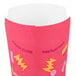 A pink Solo paper container with yellow and orange graphic designs.