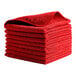 A stack of pink Rubbermaid microfiber cloths.