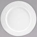 An Arcoroc white porcelain dinner plate with a swirl design.