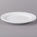 An Arcoroc white porcelain bread and butter plate with a rim.