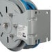 A T&S metal hose reel with a blue hose attached.
