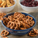 A Carlisle Dallas Ware cafe blue nappie bowl filled with pretzels on a table.