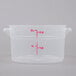 A translucent plastic container with red measurement lines.