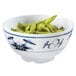 A close up of a blue and white GET Water Lily melamine bowl filled with green beans.