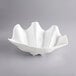 A white Winco plastic bowl with a wavy shell design on the edge.