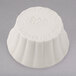 A white round Hall China ramekin with a number and text on the bottom.