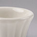 A Hall China ivory flared ramekin with a small rim.