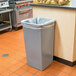 A grey Continental Swingline square trash can in a kitchen.