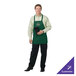 A man wearing a Chef Revival hunter green apron with three pockets.