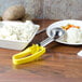 A yellow Vollrath extended length disher next to a bowl of mashed potatoes.