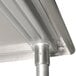 A stainless steel mixer table with a galvanized metal undershelf.