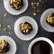 a group of chocolate candies with chocolate chips and a cup of hot chocolate