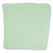 A green microfiber cloth with a white border.