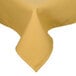 A yellow rectangular tablecloth with a folded edge on a table.