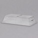 A clear plastic rectangular tray cover with a center hinge over a Cal-Mil bakery display tray.