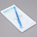 Royal Paper Mexican themed guest check with beverage lines and bottom guest receipt on a counter with a pen.