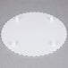 A white Wilton round scalloped edge cake separator plate with three small plastic holes.
