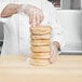 a hand holding a stack of bread