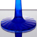 a blue glass stem on a table