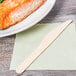 A plate of fish with an Eco-gecko wooden knife on a table.