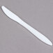 a white plastic knife on a gray background