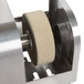 A metal object with a circular stone, the Edlund A526SSP replacement grinding wheel assembly.