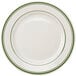 A white Tuxton china plate with green bands on the rim.