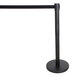 A black Aarco crowd control stanchion with a black retractable belt.