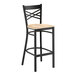 A black metal bar stool with a cross back design and a light wood seat.