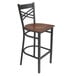 A Lancaster Table & Seating black bar stool with a wooden seat and back.