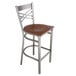 A Lancaster Table & Seating metal bar stool with a wooden seat.