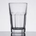 A close-up of an Arcoroc Gotham beverage glass with a rim.