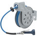 A T&amp;S steel hose reel with a blue and white hose attached to it.