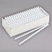 A white box of Fellowes white plastic binding combs.