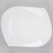 A CAC bone white porcelain peach plate with a curved edge.