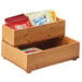 A wood stacking box with snacks on a counter.
