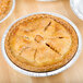 A close up of a pie in a D&W Fine Pack tin foil pie pan.