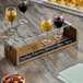 A Cal-Mil wine tasting flight set on a table with a glass of red wine.