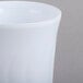 A close up of a white Fineline Flairware plastic coffee mug.