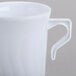 A close up of a Fineline white plastic coffee mug with a handle.